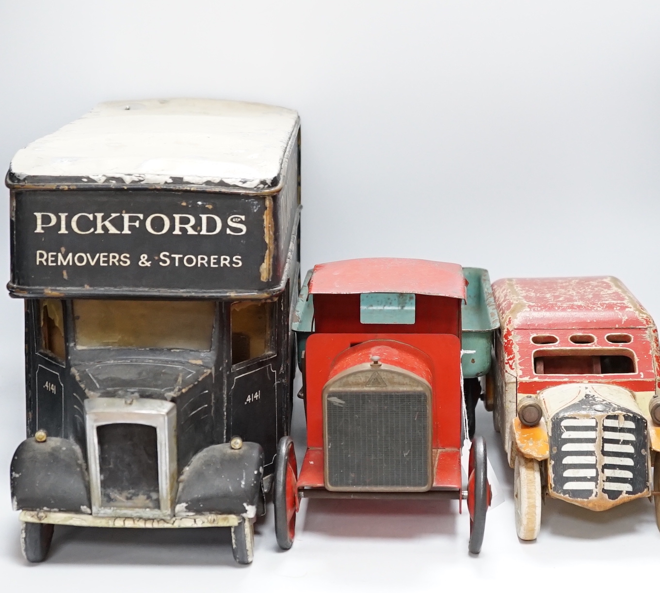 Three model vehicles including; a tinplate Tri-ang tipper lorry, a Pickfords removal van (believed to have been used as a shop window display) and a wooden bus, length of Pickfords van 54cm